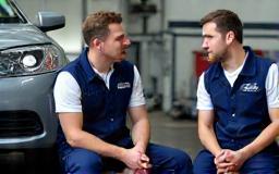 Consultation with staff and car owner on garage floor