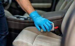 Technician deep cleaning a car interior
