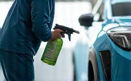 Technician spraying eco-friendly solution on car